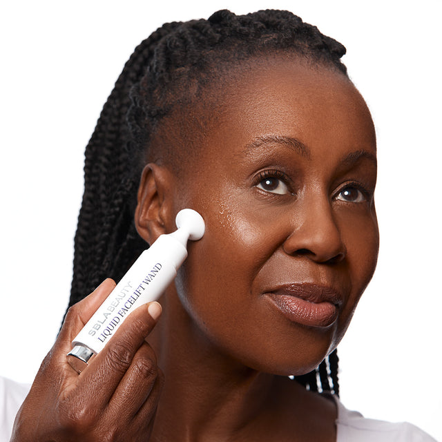 Model 4 applying liquid facelift to cheek